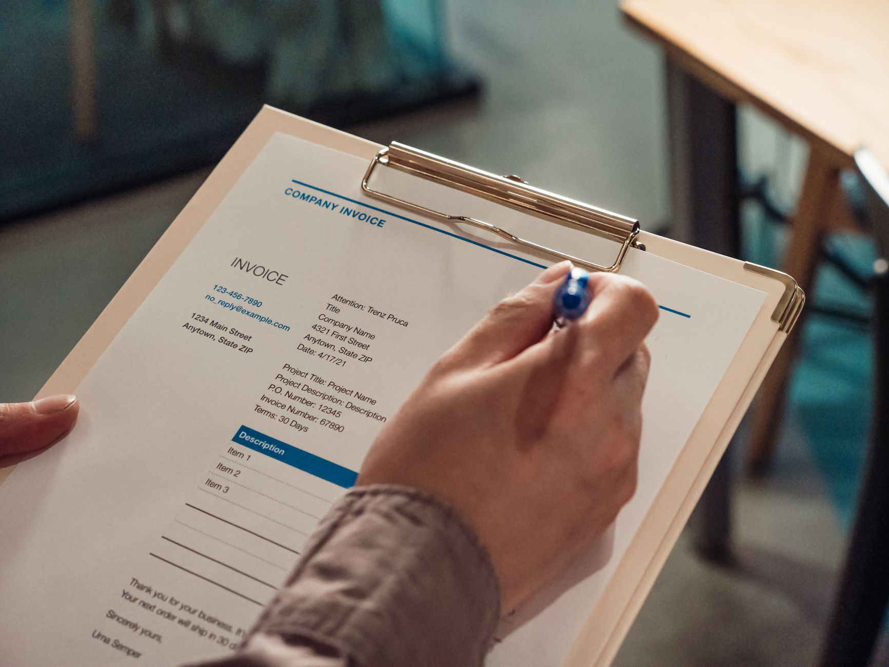 A clean, organized company invoice on a clipboard