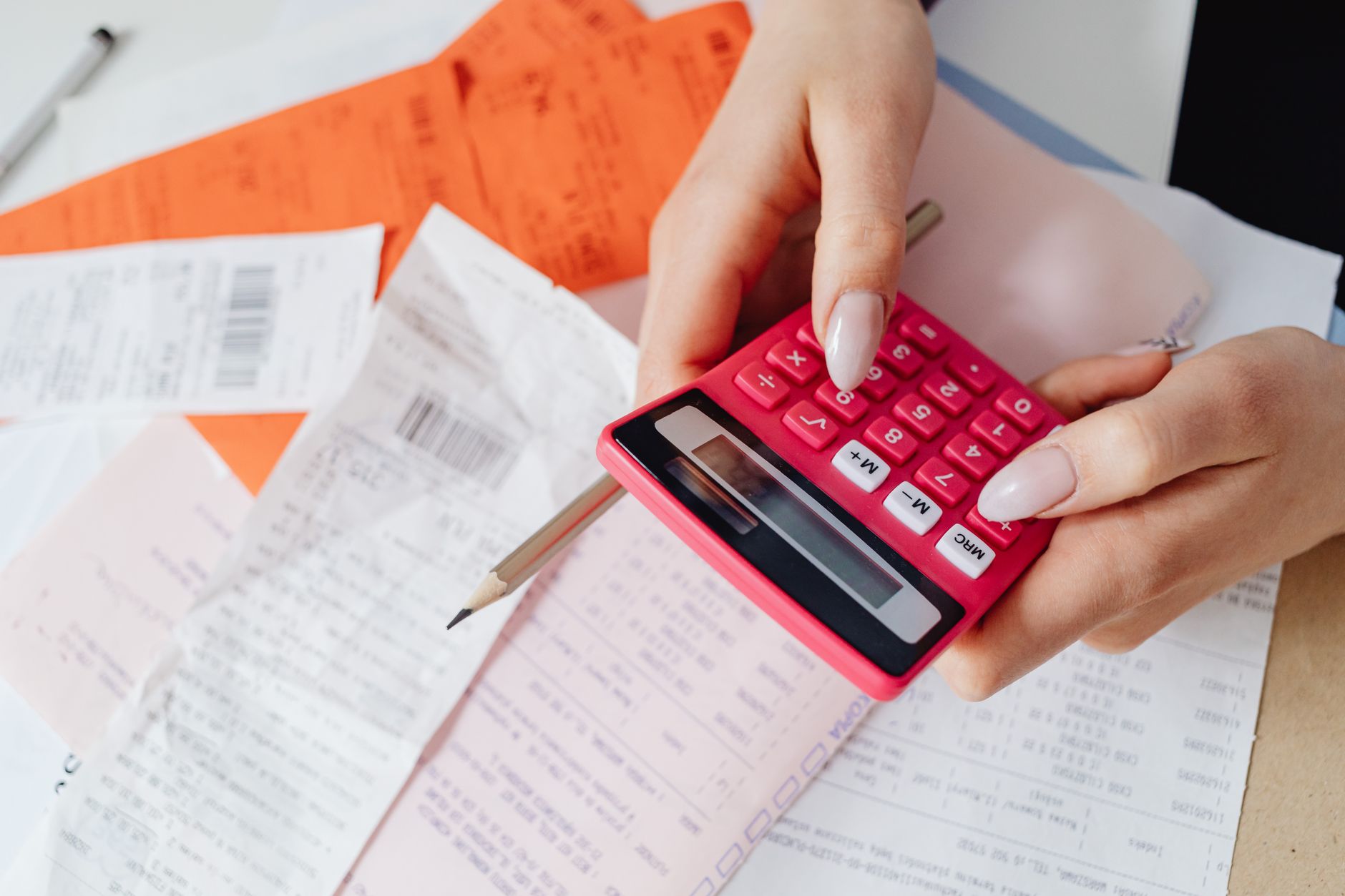 Receipts and a calculator scattered across a desk